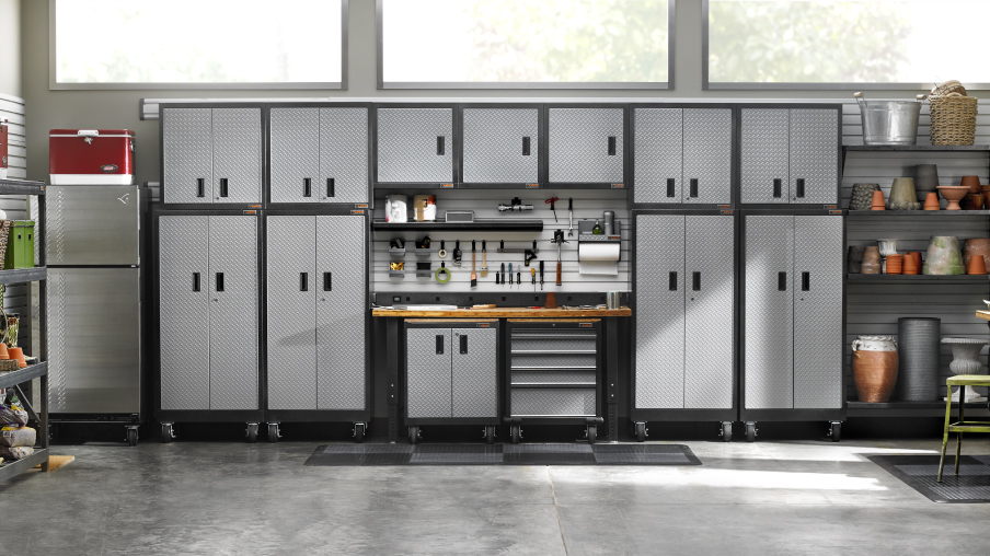 Une série d’armoires Gladiator et d’unités de rangement Gladiator. À côté se trouvent des tablettes avec des pots de jardin ainsi qu’un réfrigérateur.