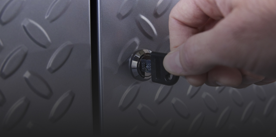 Someone turns a key in a Gladiator Storage Unit