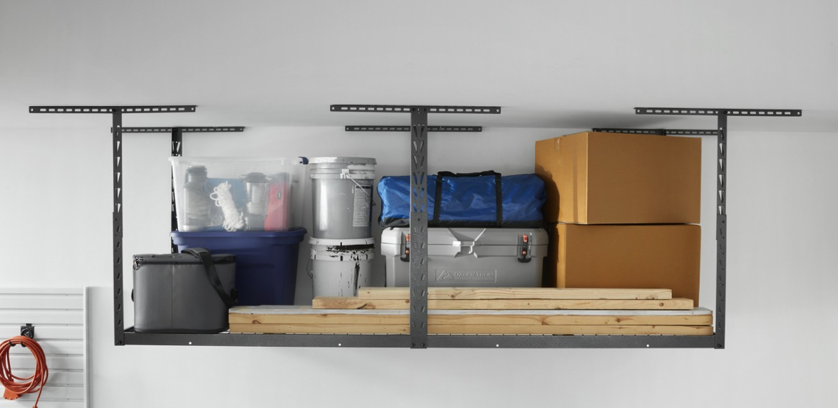 In Gladiator Overhead Storage are a grey bag, blue bin, two canisters, grey bin, blue bag, two boxes and lumber.
