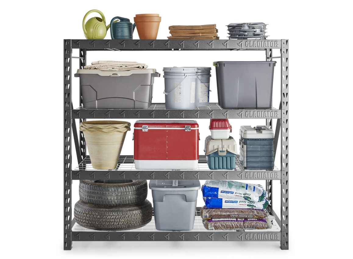 A Gladiator Shelving Unit with watering cans, yard waste bags, bins, tires and bags of soil