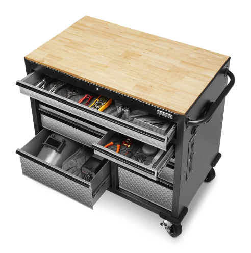 A 41 inch 9-drawer Gladiator Mobile Tool Workbench with solid wood top. Some drawers are opened, revealing various tools like pliers and a welder's helmet
