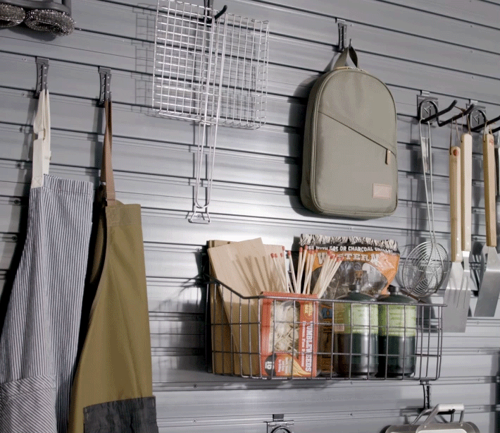 An animated GIF showing different close-ups of a wall. Each close-up features GearWall Panels with a variety of these items hanging: aprons, kitchen utensils, several pans and baskets with propane tanks, matches and other items.