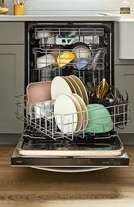 An open Whirlpool® Dishwasher with dishes inside