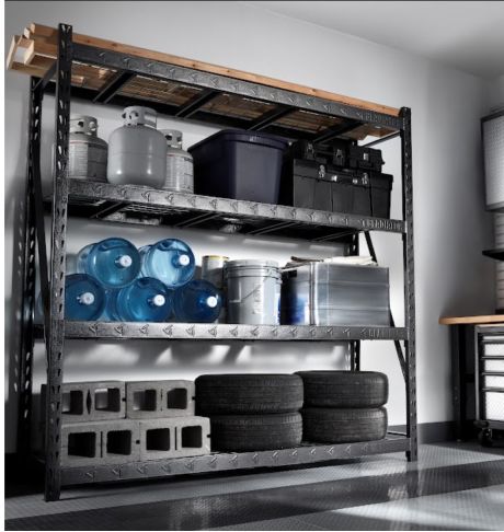 Rack Shelving with propane tanks and bins on the top shelf, water cooler jugs, a bucket and a bin on the middle shelf and cinder blocks and tires on the bottom shelf