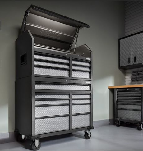 A Gladiator Tool Storage Unit with the top compartment opened. Next to it are Gladiator Cabinets